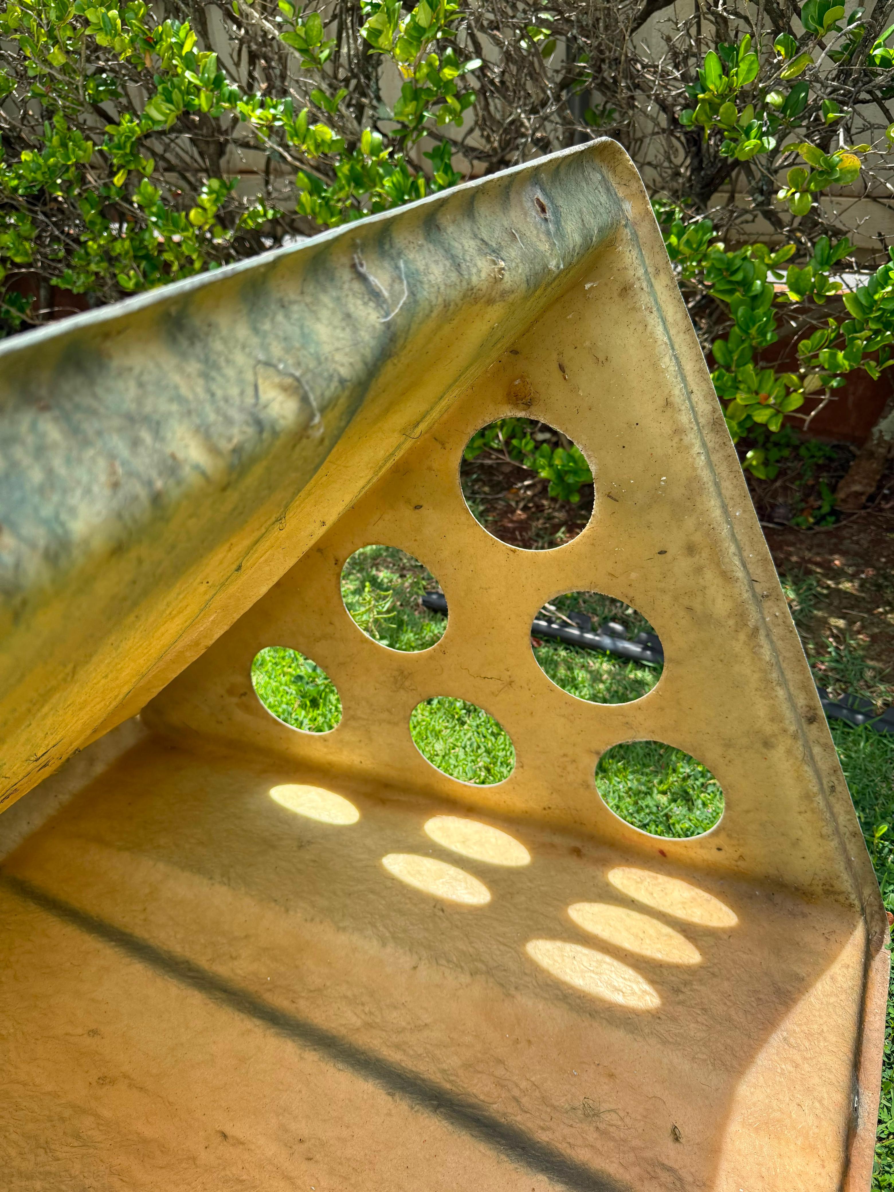 Interior of the A-frame coop on grass, sunlight through six end vents